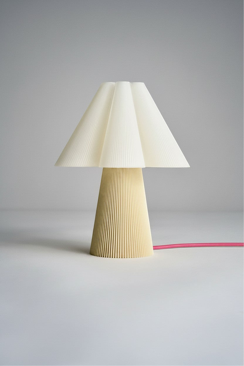 Layerd Bloom Chalk table lamp with pleated cream shade and yellow base. Made from PLA.
