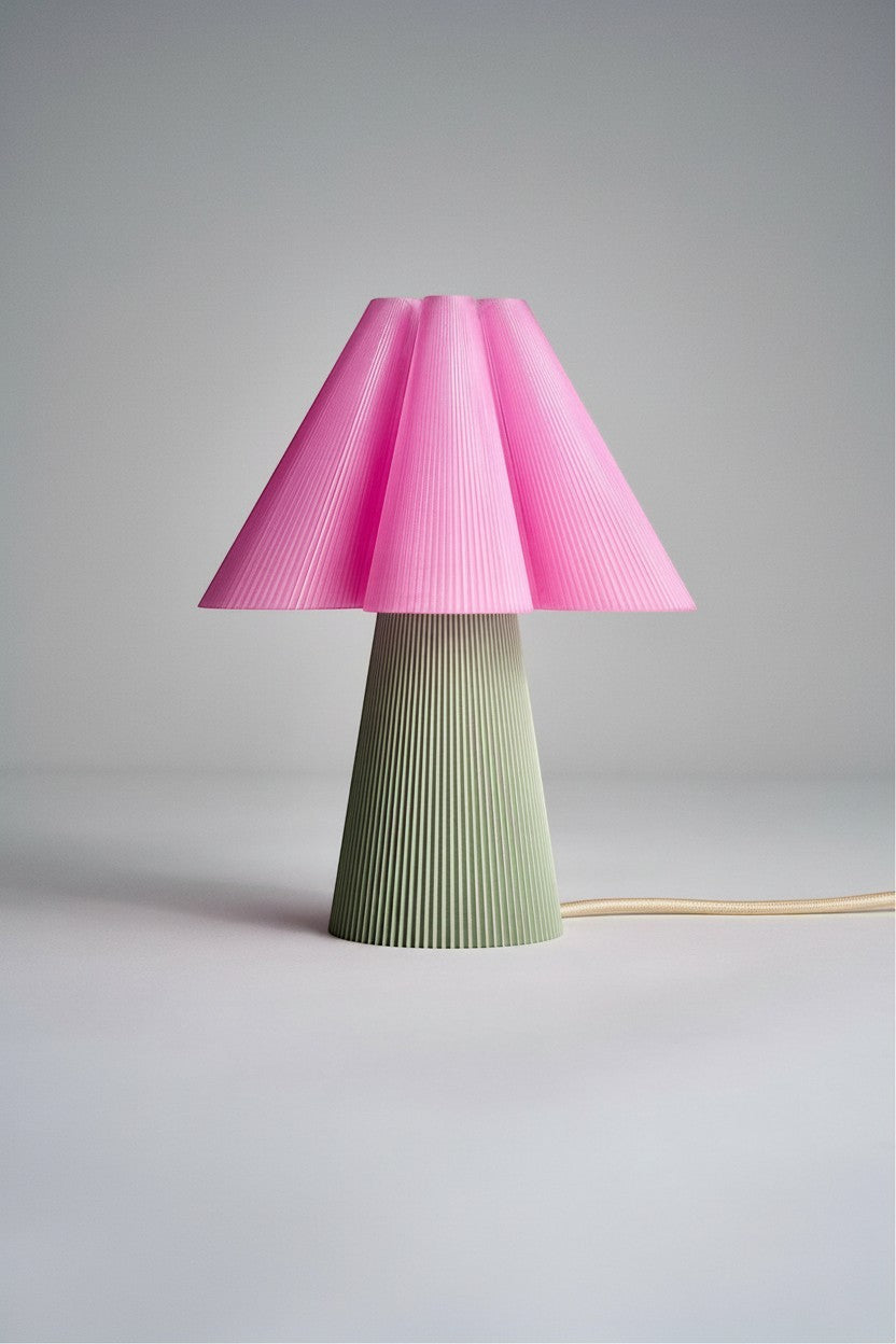 Layerd Bloom Clash table lamp with pink pleated shade and sage green pleated base, made of PLA.