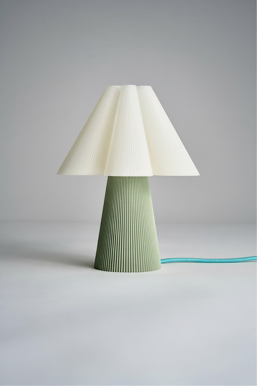 Layerd Bloom Sage table lamp with pleated cream shade and green base. PLA material.